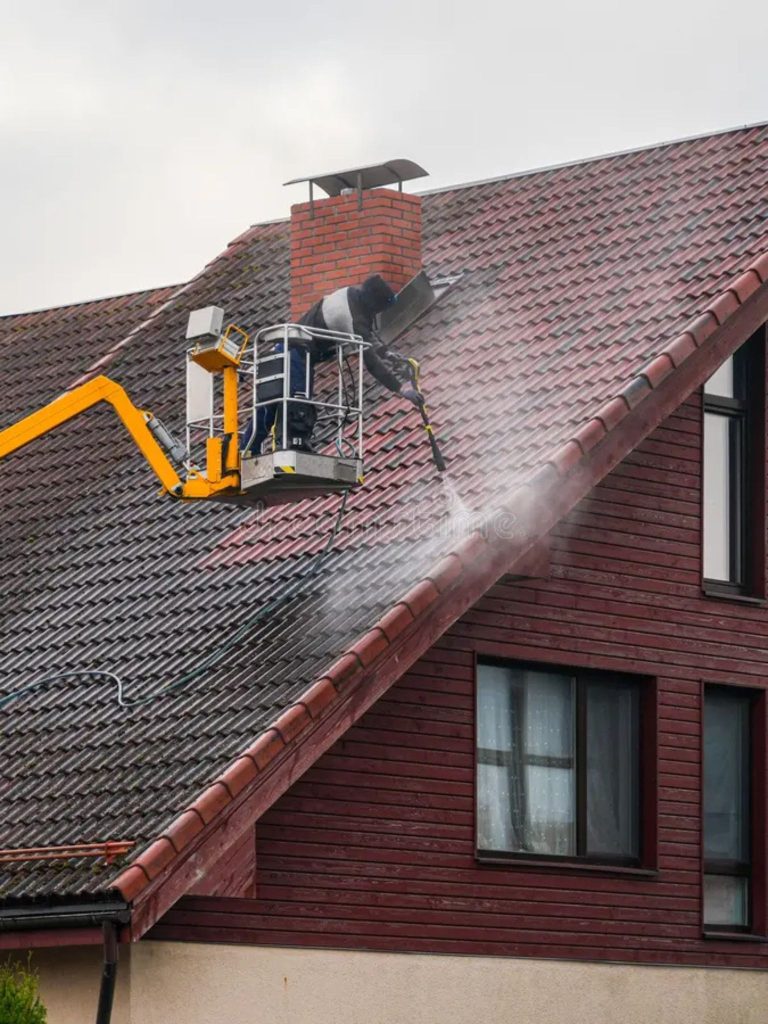 Cleaning a roof on a lift