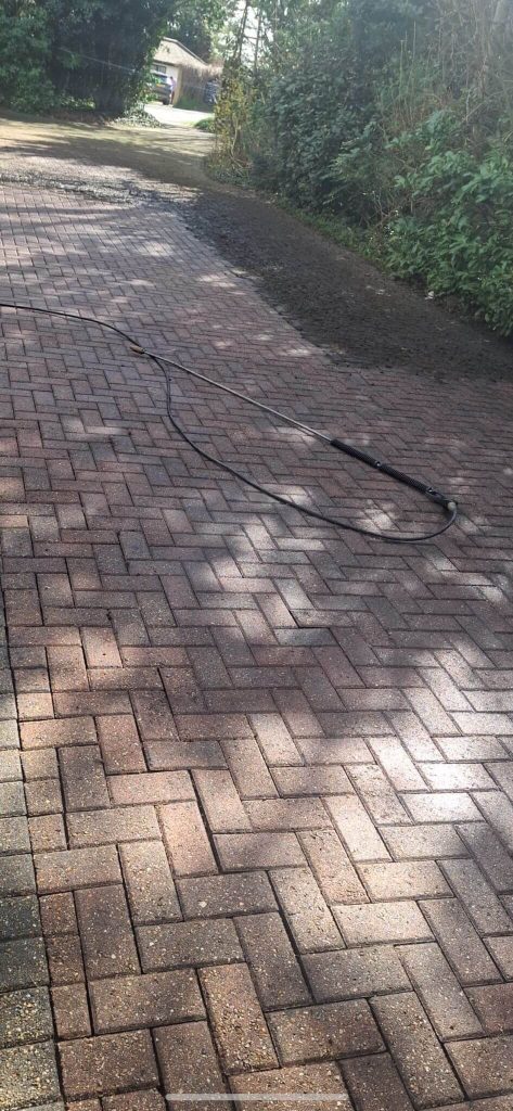 power washing a brick paver driveway